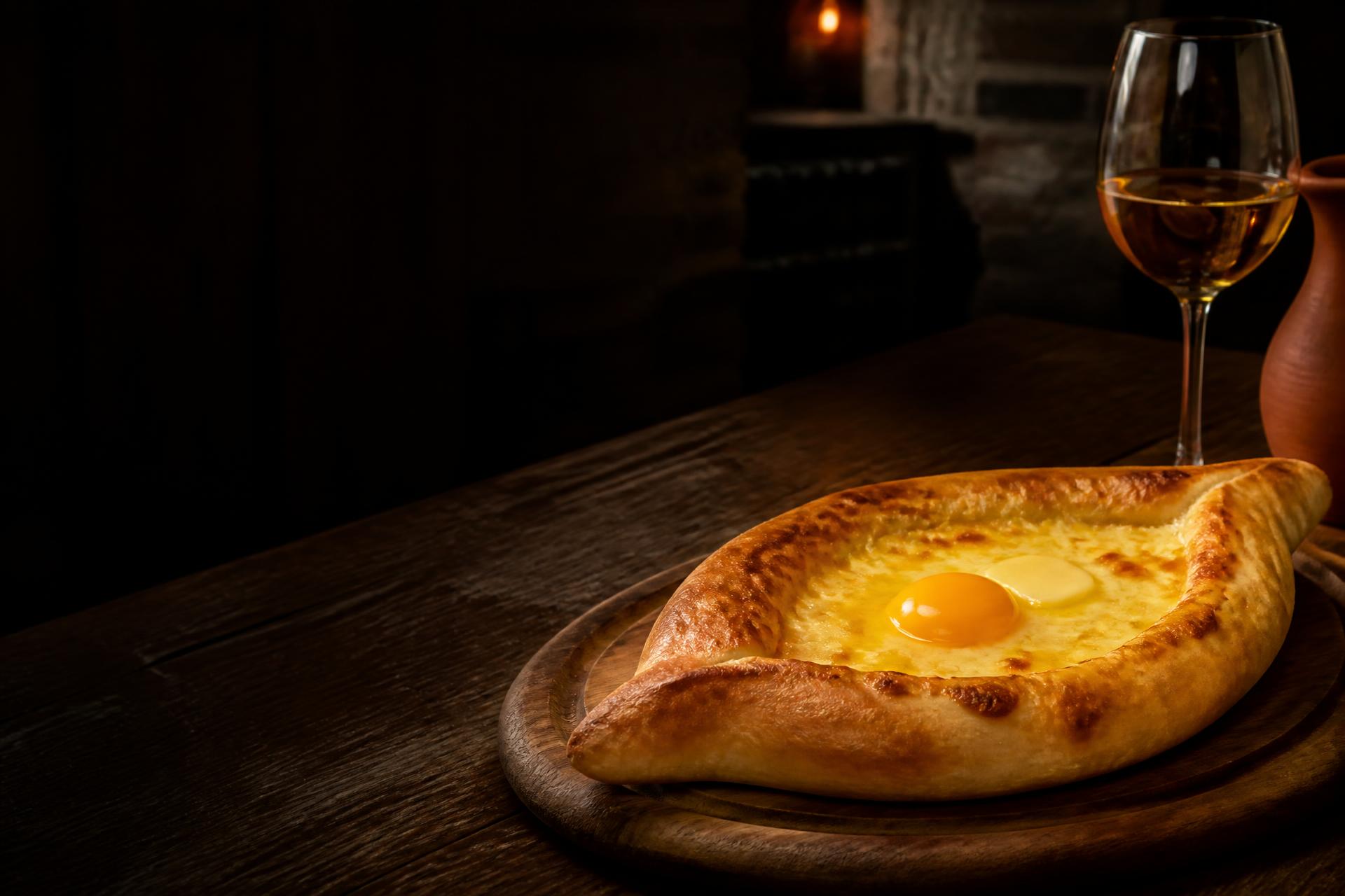 Adjaruli khachapuri with a golden egg yolk and Georgian amber wine